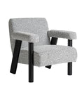 Sillón estilo art deco gris y negro con estructura cuadrada y tapizado en algodón bouclé.